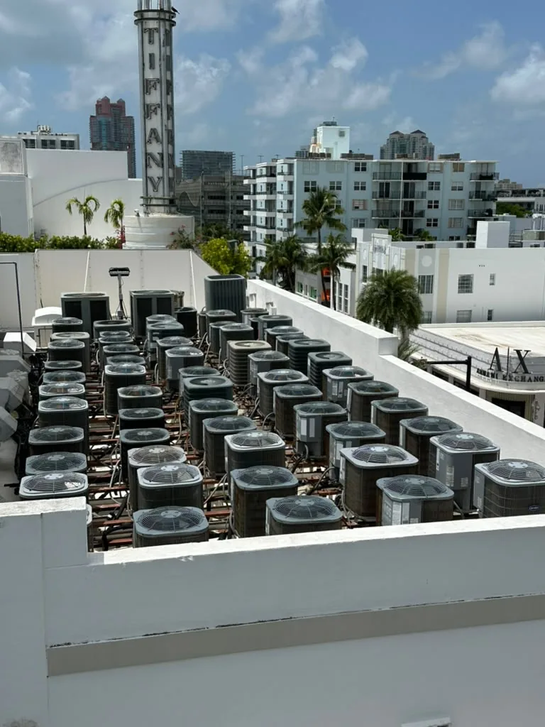 Large bank of rooftop condenser fans at a commercial building